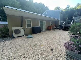 rear view of property featuring ac unit