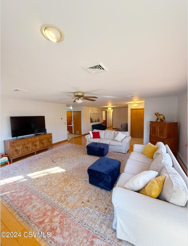 living room featuring hardwood / wood-style flooring and ceiling fan