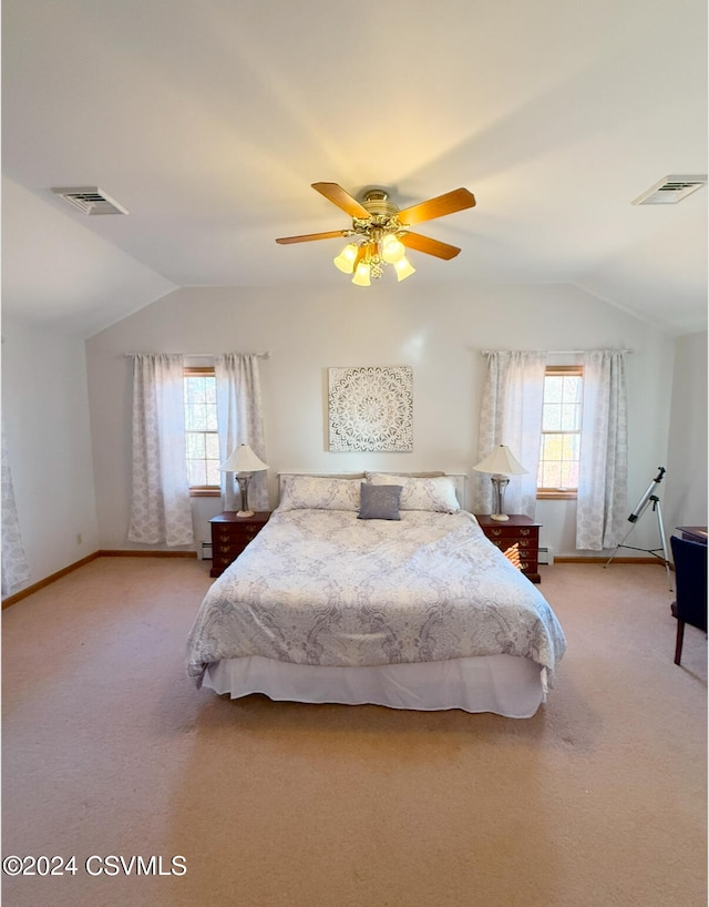 carpeted bedroom with multiple windows, vaulted ceiling, and ceiling fan