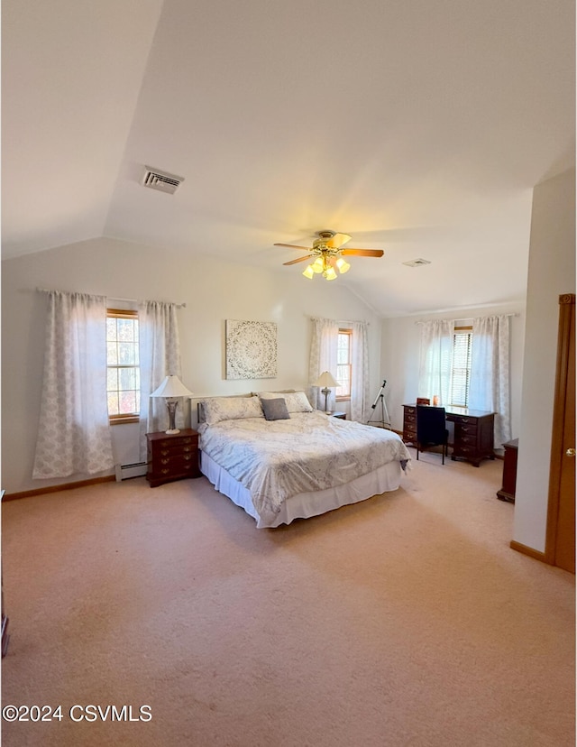 unfurnished bedroom featuring multiple windows, vaulted ceiling, and carpet floors