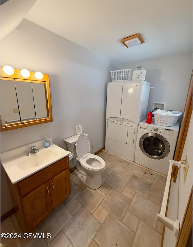 bathroom featuring separate washer and dryer, vanity, and toilet