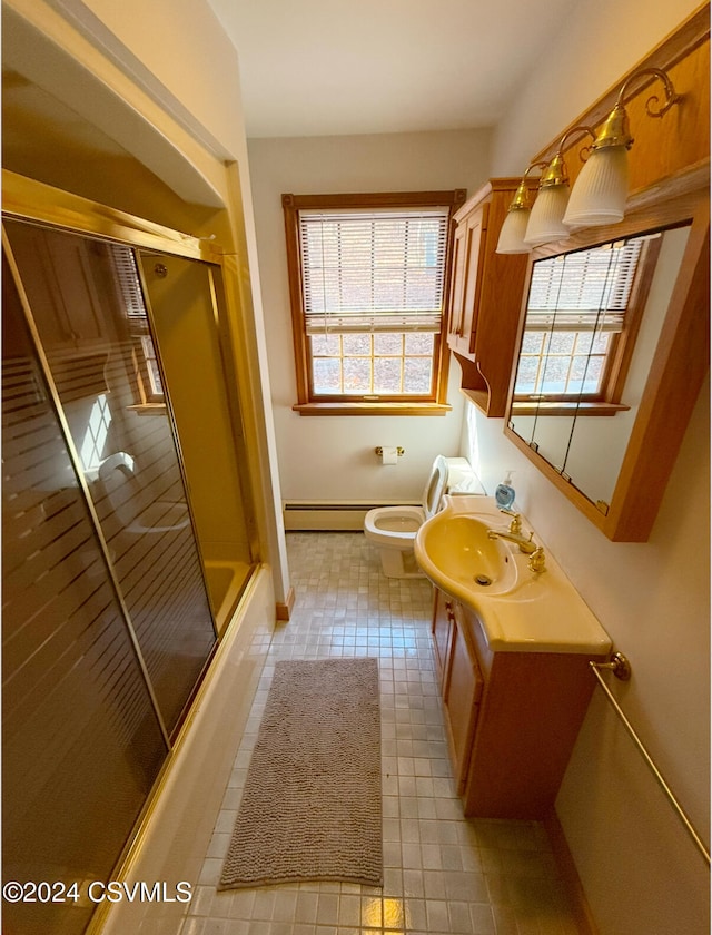 full bathroom with tile patterned flooring, baseboard heating, combined bath / shower with glass door, vanity, and toilet