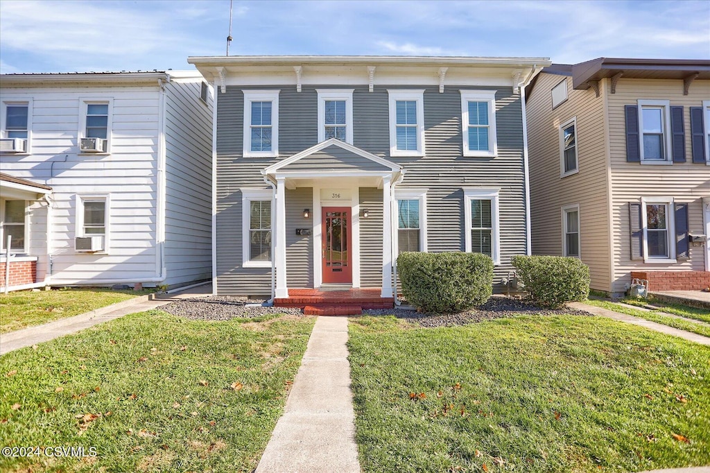 view of front of house featuring cooling unit and a front yard