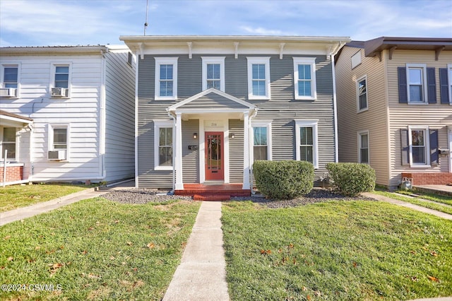 view of front of house featuring cooling unit and a front yard