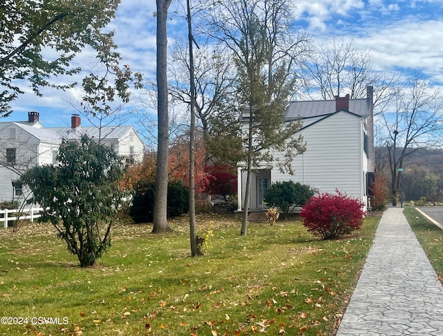 view of side of home with a yard