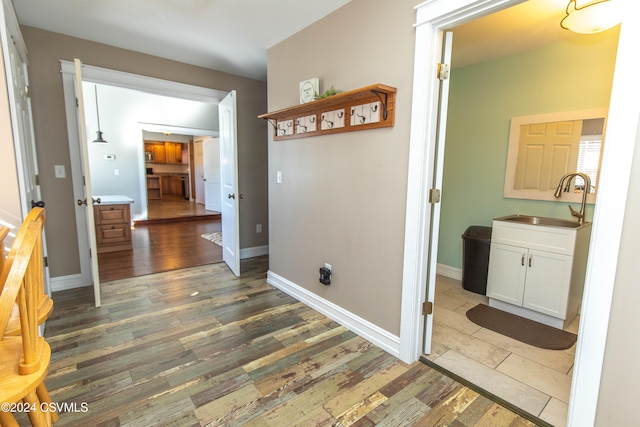 corridor featuring sink and dark hardwood / wood-style floors