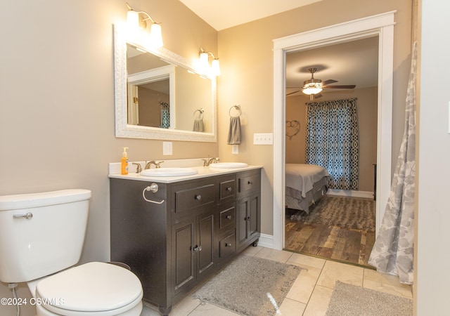 bathroom with hardwood / wood-style floors, vanity, ceiling fan, and toilet