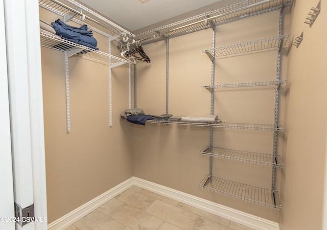 walk in closet featuring tile patterned flooring