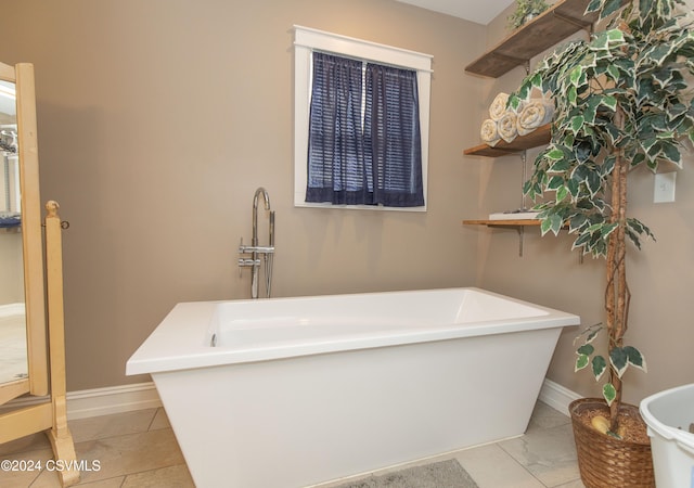 bathroom with a tub to relax in and tile patterned floors