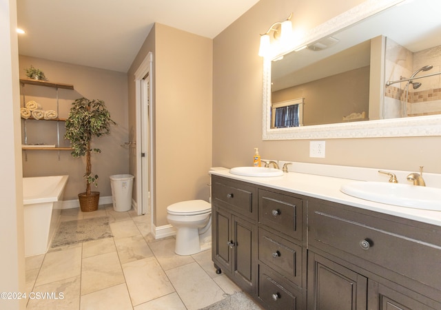 bathroom with a tile shower, vanity, and toilet