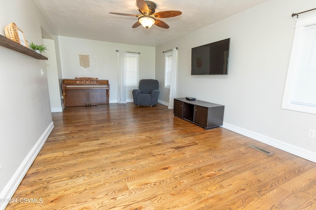 unfurnished living room featuring light hardwood / wood-style floors and ceiling fan