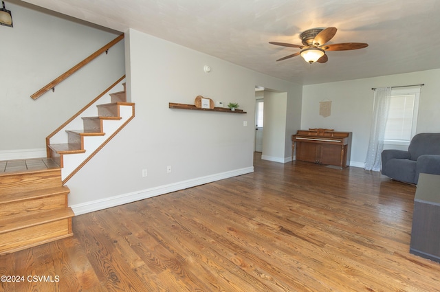 unfurnished living room with ceiling fan and wood-type flooring