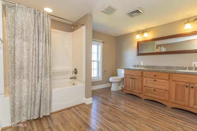 full bathroom featuring shower / tub combo with curtain, wood-type flooring, toilet, and vanity