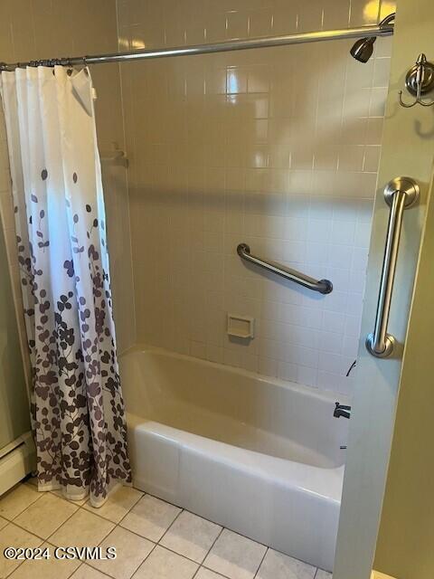 bathroom featuring baseboard heating, tile patterned flooring, and shower / tub combo with curtain