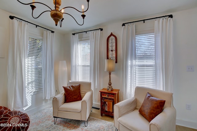 living area with a chandelier and light hardwood / wood-style flooring