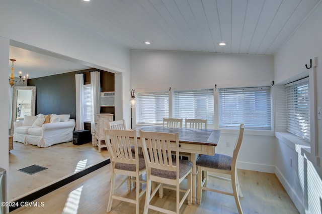 dining room featuring light wood-type flooring, lofted ceiling, an inviting chandelier, and wooden ceiling