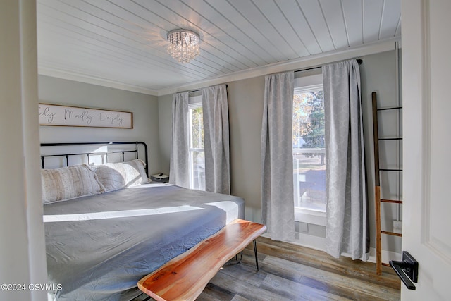 bedroom with multiple windows, wood ceiling, hardwood / wood-style flooring, and ornamental molding