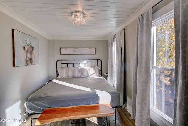 bedroom with wood ceiling, hardwood / wood-style floors, and ornamental molding