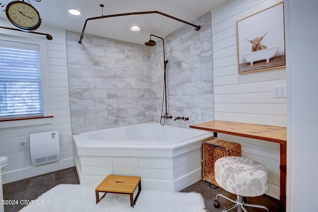 bathroom featuring tiled shower / bath, toilet, and heating unit