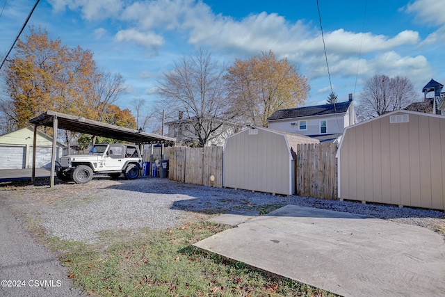 view of yard featuring a shed and a carport