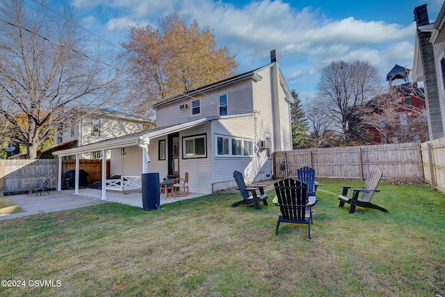 back of property featuring a lawn and a patio area