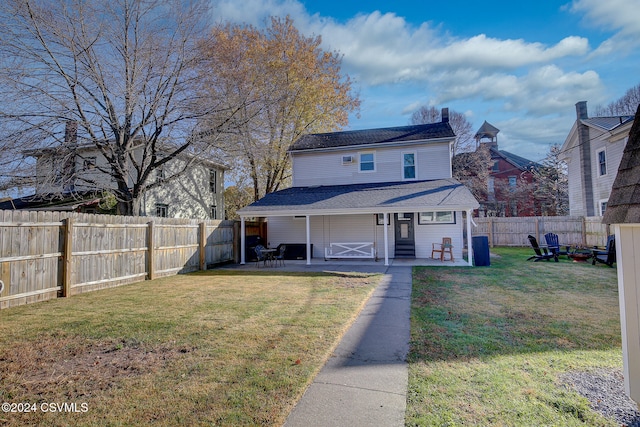 view of front of property featuring a front lawn and a patio area