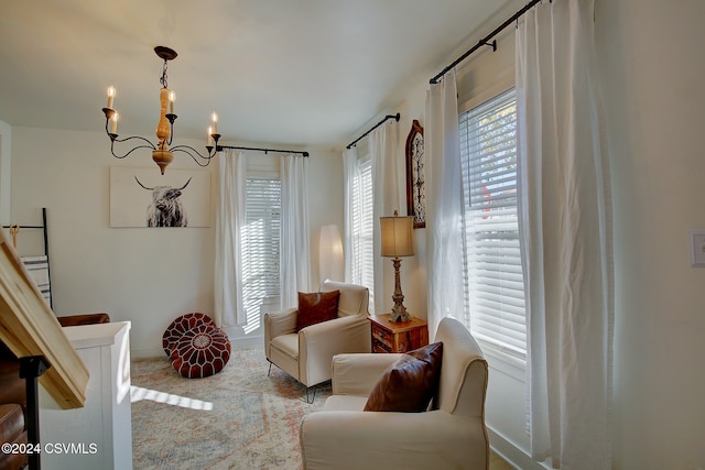 living area featuring carpet flooring and an inviting chandelier