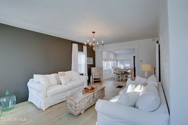 living room featuring light wood-type flooring and a chandelier