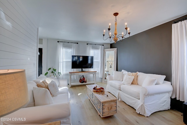 living room featuring light hardwood / wood-style floors and a chandelier