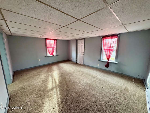 basement featuring carpet and a paneled ceiling