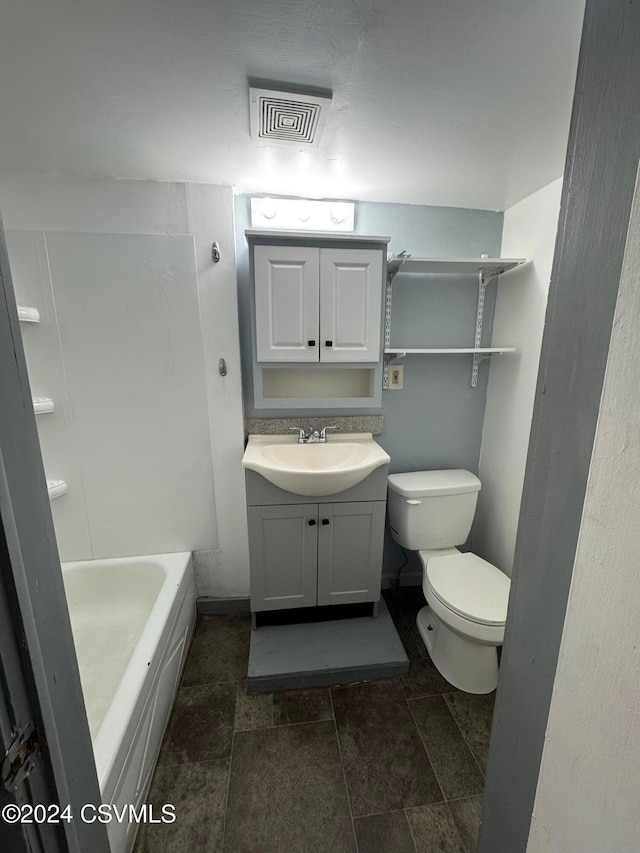 bathroom with vanity, toilet, and a bath