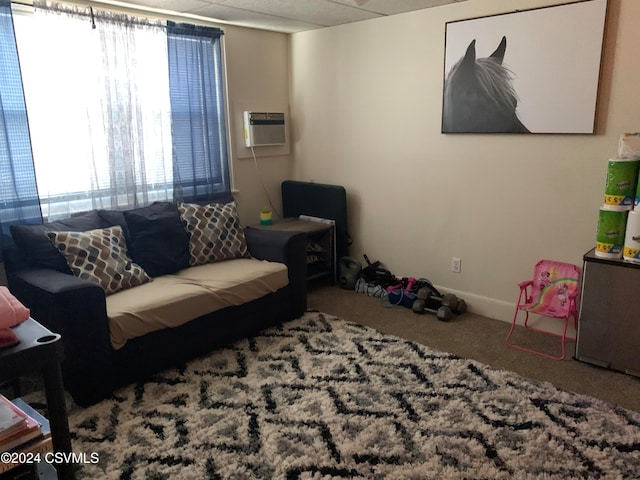 living room featuring an AC wall unit and carpet