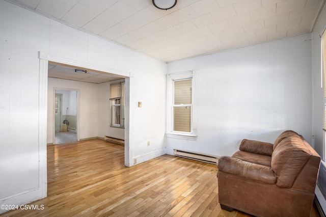 living area with light hardwood / wood-style floors and a baseboard radiator