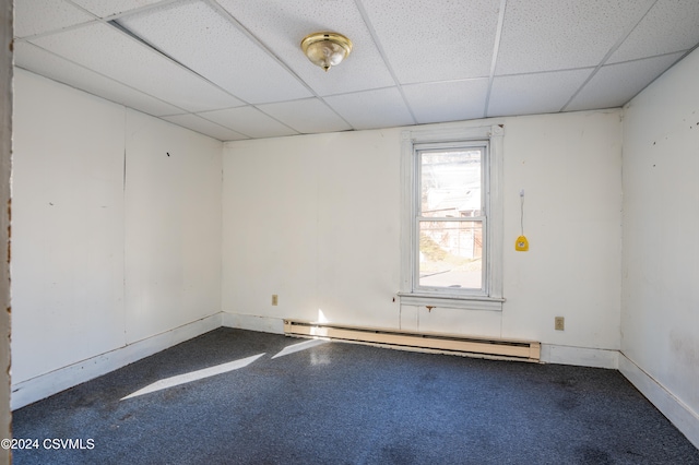 spare room featuring carpet flooring, a drop ceiling, and a baseboard radiator