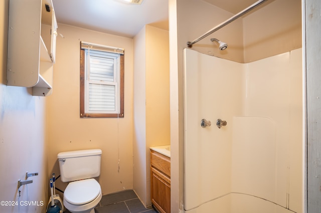 bathroom featuring vanity, toilet, walk in shower, and tile patterned flooring