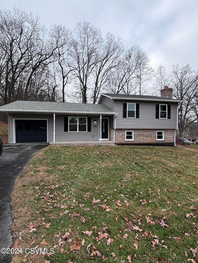 split level home with a front yard and a garage