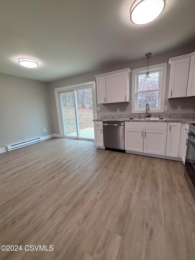 kitchen with sink, stainless steel dishwasher, baseboard heating, plenty of natural light, and white cabinetry