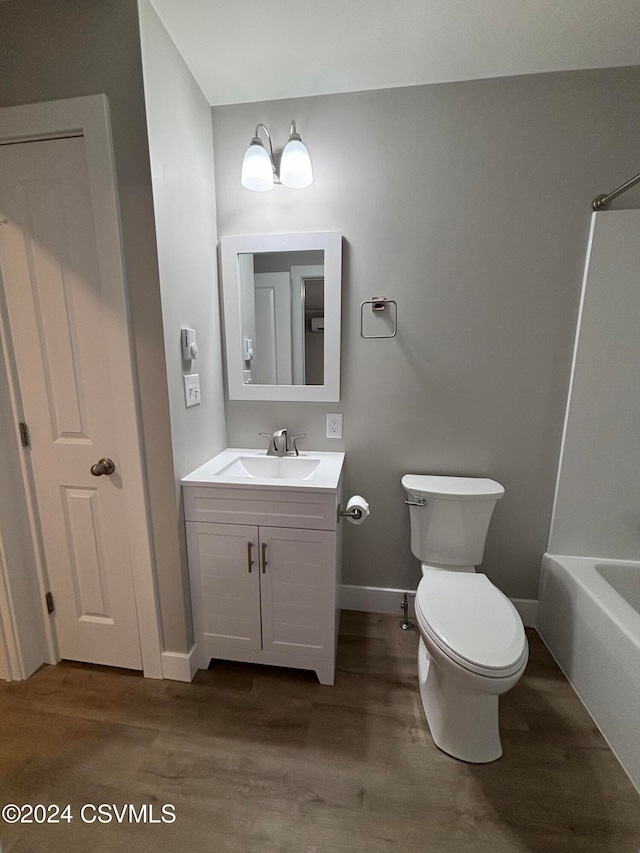 full bathroom featuring vanity,  shower combination, toilet, a notable chandelier, and wood-type flooring