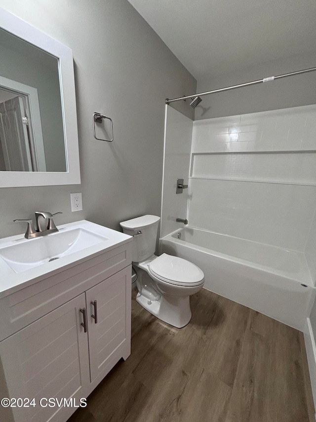 full bathroom with hardwood / wood-style floors, vanity, toilet, and tub / shower combination