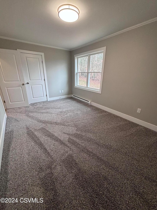 carpeted spare room featuring baseboard heating and ornamental molding