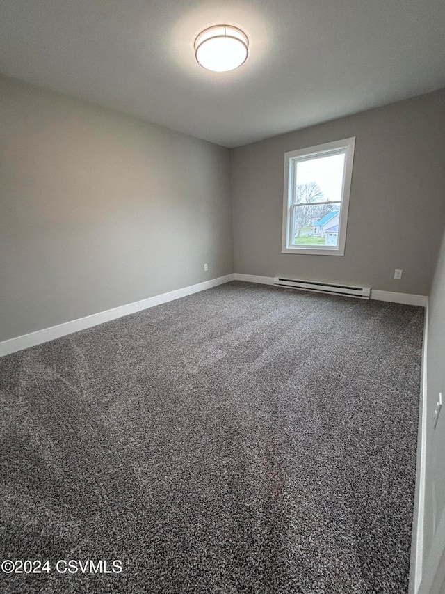 empty room featuring carpet flooring and a baseboard radiator