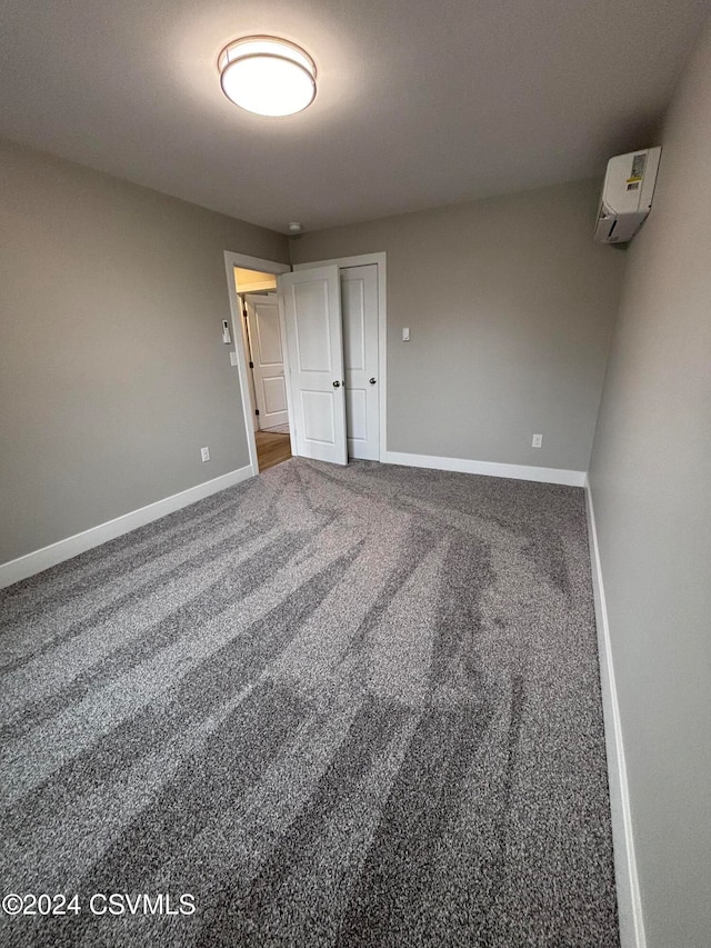 carpeted empty room with a wall mounted air conditioner