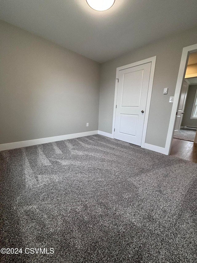 empty room featuring dark carpet