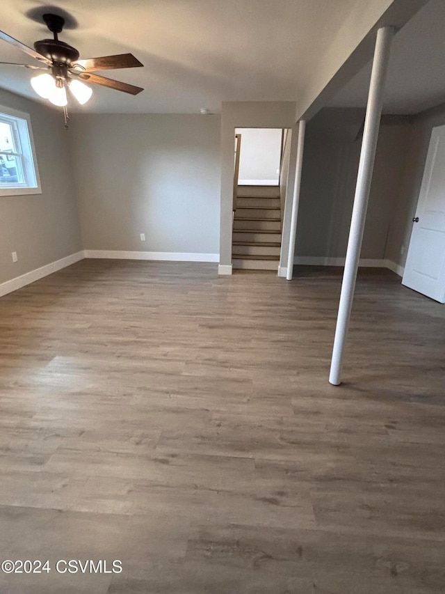 basement featuring ceiling fan and hardwood / wood-style flooring