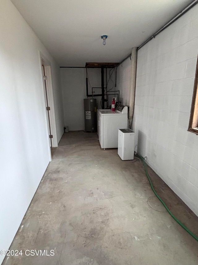 basement featuring water heater and washer and clothes dryer