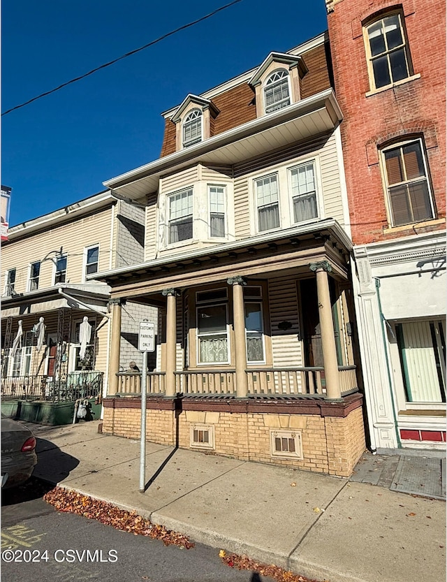 view of property featuring a porch