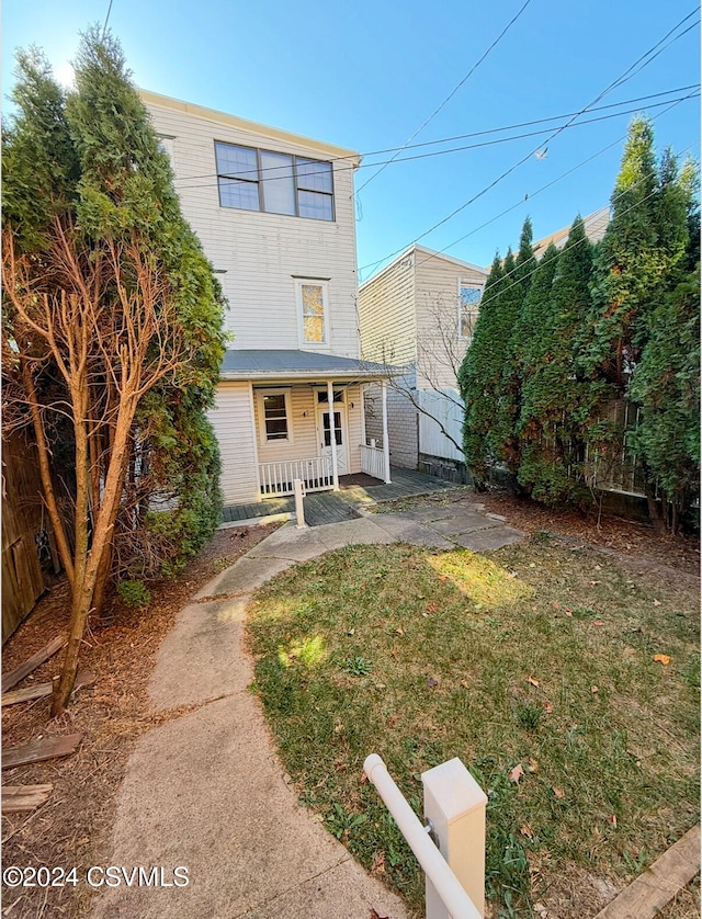 view of front of home with a porch and a front yard