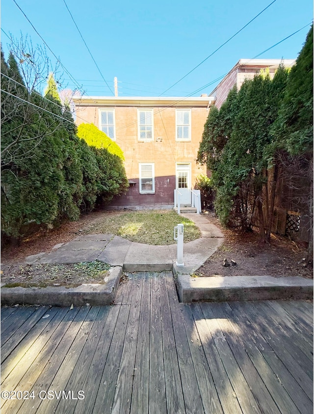 back of property featuring a deck