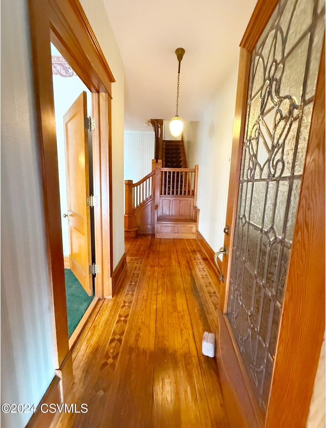 corridor with hardwood / wood-style floors