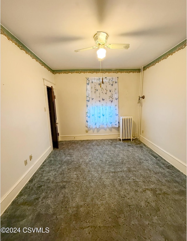 carpeted spare room featuring ceiling fan and radiator heating unit